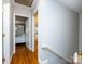 Hallway with hardwood flooring and access to bedrooms at 6941 Queensberry Dr, Charlotte, NC 28226