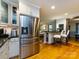 Open kitchen design with stainless steel appliances, breakfast bar, and view to the living room at 6941 Queensberry Dr, Charlotte, NC 28226
