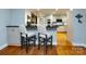 Kitchen bar with seating featuring a dark countertop and white cabinetry at 6941 Queensberry Dr, Charlotte, NC 28226