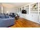 Spacious living room with hardwood floors, custom built-ins, and comfortable seating area at 6941 Queensberry Dr, Charlotte, NC 28226
