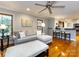 Cozy living room with hardwood floors, grey sofa, and view to the kitchen bar at 6941 Queensberry Dr, Charlotte, NC 28226