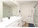 Bright bathroom with a white double vanity and glass enclosed shower at 7024 Jane Parks Way, Charlotte, NC 28217