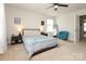 Cozy bedroom with a ceiling fan, neutral walls, and dark bedside tables at 7024 Jane Parks Way, Charlotte, NC 28217