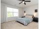 Neutral primary bedroom with a ceiling fan, and large window at 7024 Jane Parks Way, Charlotte, NC 28217