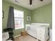 Green-painted bedroom featuring a crib with changing table and decorative decals at 7024 Jane Parks Way, Charlotte, NC 28217