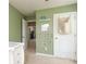 Green-painted bedroom with closet and view into another room at 7024 Jane Parks Way, Charlotte, NC 28217
