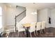 Bright dining area features a wooden table, upholstered chairs, and a modern chandelier at 7024 Jane Parks Way, Charlotte, NC 28217