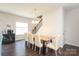A well-lit dining room with dark wood floors and a modern table setting at 7024 Jane Parks Way, Charlotte, NC 28217