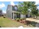 Charming two-story home with a landscaped front yard, attached garage, and inviting covered porch at 7024 Jane Parks Way, Charlotte, NC 28217