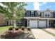 Charming two-story townhome featuring an attached one-car garage and a well-manicured front yard at 7024 Jane Parks Way, Charlotte, NC 28217