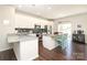 Modern kitchen features white cabinetry, granite countertops, stainless steel appliances, and an island with seating at 7024 Jane Parks Way, Charlotte, NC 28217