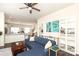 Open living area with a blue sectional sofa seamlessly flowing into the kitchen and dining space at 7024 Jane Parks Way, Charlotte, NC 28217