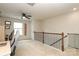 Upstairs loft area features wood railing and neutral carpet at 7024 Jane Parks Way, Charlotte, NC 28217