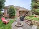 Spacious backyard with a fire pit, grill, and patio seating, ideal for outdoor gatherings and relaxation at 705 Woburn Abbey Dr, Fort Mill, SC 29715