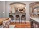 View of the bar area with seating, connecting the kitchen and living space at 705 Woburn Abbey Dr, Fort Mill, SC 29715