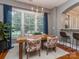 The dining room boasts a large window, modern chandelier, and hardwood floors, seamlessly connects to the kitchen at 705 Woburn Abbey Dr, Fort Mill, SC 29715