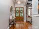 Warm and inviting foyer with wood flooring, decorative mirror and a view to a living area at 705 Woburn Abbey Dr, Fort Mill, SC 29715