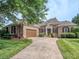 Charming brick and stone home featuring a lush lawn, decorative shutters and a well-manicured front yard at 705 Woburn Abbey Dr, Fort Mill, SC 29715
