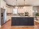 Modern kitchen with stainless steel appliances, a large island, and pendant lighting at 705 Woburn Abbey Dr, Fort Mill, SC 29715