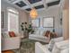 Bright living room featuring neutral decor, a coffered ceiling and a green patterned rug at 705 Woburn Abbey Dr, Fort Mill, SC 29715