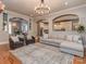 Spacious living room open to the kitchen with hardwood floors, a cozy seating area and natural light at 705 Woburn Abbey Dr, Fort Mill, SC 29715