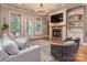 Comfortable living room with hardwood floors, a fireplace, and built-in shelving at 705 Woburn Abbey Dr, Fort Mill, SC 29715