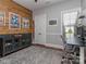 Office space with wood-paneled wall, grey built-ins, desk, and a view of the outdoors at 705 Woburn Abbey Dr, Fort Mill, SC 29715