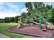 Colorful playground featuring slides, climbing structures, and a soft ground cover for safety at 705 Woburn Abbey Dr, Fort Mill, SC 29715