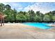 Large community pool surrounded by trees and lounge chairs offering a resort-like feel at 705 Woburn Abbey Dr, Fort Mill, SC 29715