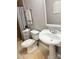 Bathroom featuring tiled shower, pedestal sink, and neutral decor at 7133 Tall Tree Ln, Charlotte, NC 28214