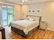 Cozy bedroom with hardwood floors, natural lighting, and patio access at 7133 Tall Tree Ln, Charlotte, NC 28214
