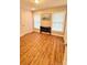 Bedroom featuring hardwood floors, two windows, and a closet at 7133 Tall Tree Ln, Charlotte, NC 28214
