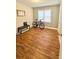 Bedroom featuring a laminate wood floor, window, bench, and bicycle at 7133 Tall Tree Ln, Charlotte, NC 28214