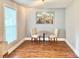 Bright dining room featuring hardwood floors, a round table, and natural light from the window at 7133 Tall Tree Ln, Charlotte, NC 28214