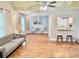 Bright living room with hardwood floors, modern decor, and a unique mural overhead, perfect for entertaining at 7133 Tall Tree Ln, Charlotte, NC 28214