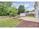 Spacious backyard features a shed, concrete patio, and a grassy area with a wooden privacy fence at 720 Reigate Rd, Charlotte, NC 28262