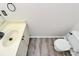 Compact bathroom features a single sink vanity, toilet, and modern flooring at 720 Reigate Rd, Charlotte, NC 28262