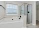 Bright bathroom featuring a soaking tub and glass enclosed shower at 720 Reigate Rd, Charlotte, NC 28262