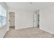 A simple bedroom with carpet floors, a closet, and a window at 720 Reigate Rd, Charlotte, NC 28262
