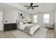 Neutral bedroom with a ceiling fan, artwork, and two windows at 720 Reigate Rd, Charlotte, NC 28262