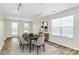 Bright dining room showcasing hardwood floors, multiple windows, and a modern aesthetic at 720 Reigate Rd, Charlotte, NC 28262