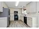 Modern kitchen with white cabinets, black appliances, and sleek countertops at 720 Reigate Rd, Charlotte, NC 28262