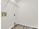 A plain laundry room with wood-look floors and white walls at 720 Reigate Rd, Charlotte, NC 28262