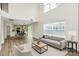 Open-concept living room boasts high ceilings, large windows, hardwood floors, and modern furnishings at 720 Reigate Rd, Charlotte, NC 28262