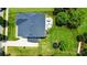 Aerial view of a private backyard with a patio, dining area, lush lawn and mature trees at 7322 Vesper Dr, Huntersville, NC 28078