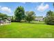 Expansive backyard featuring lush green grass and landscaping, perfect for outdoor activities and relaxation at 7322 Vesper Dr, Huntersville, NC 28078