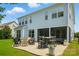 Expansive backyard with a patio, outdoor seating, lush grass, and mature landscaping at 7322 Vesper Dr, Huntersville, NC 28078