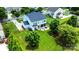 Aerial view of a large, well-maintained backyard featuring a patio, trampoline, and mature trees, all fenced-in at 7322 Vesper Dr, Huntersville, NC 28078