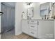 Bathroom with a double vanity, framed mirrors, contemporary fixtures and wood-look floors at 7322 Vesper Dr, Huntersville, NC 28078