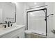 Modern bathroom featuring a glass shower with black trim, white walls, and modern fixtures at 7322 Vesper Dr, Huntersville, NC 28078